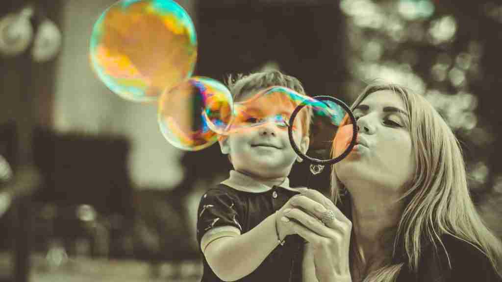 mom and child blowing bubbles