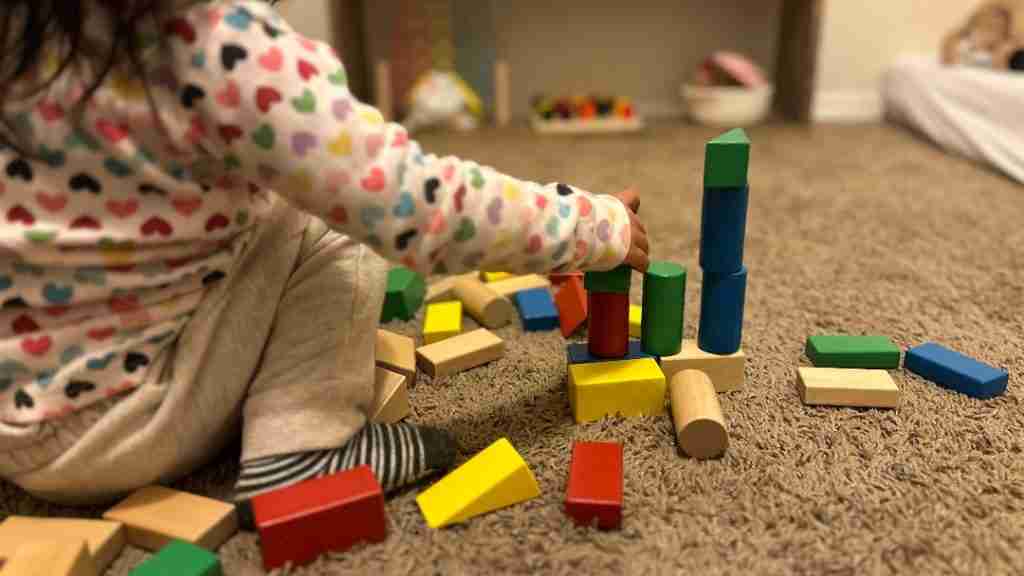 What are open ended toys child playing with building blocks