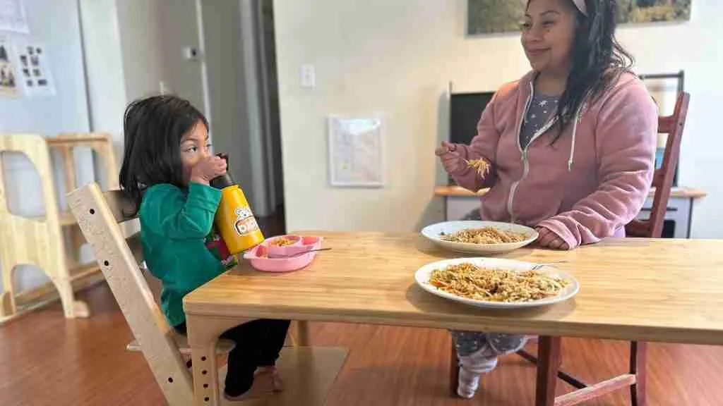 baby on the tripp trapp high chair eating at the table