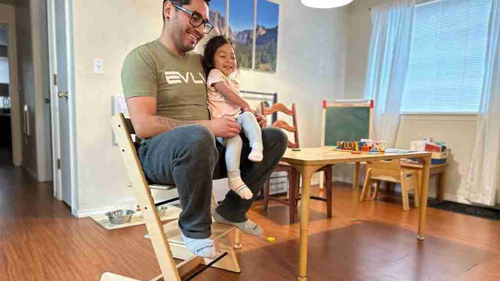 father and child seating on the Tripp Trapp high chair