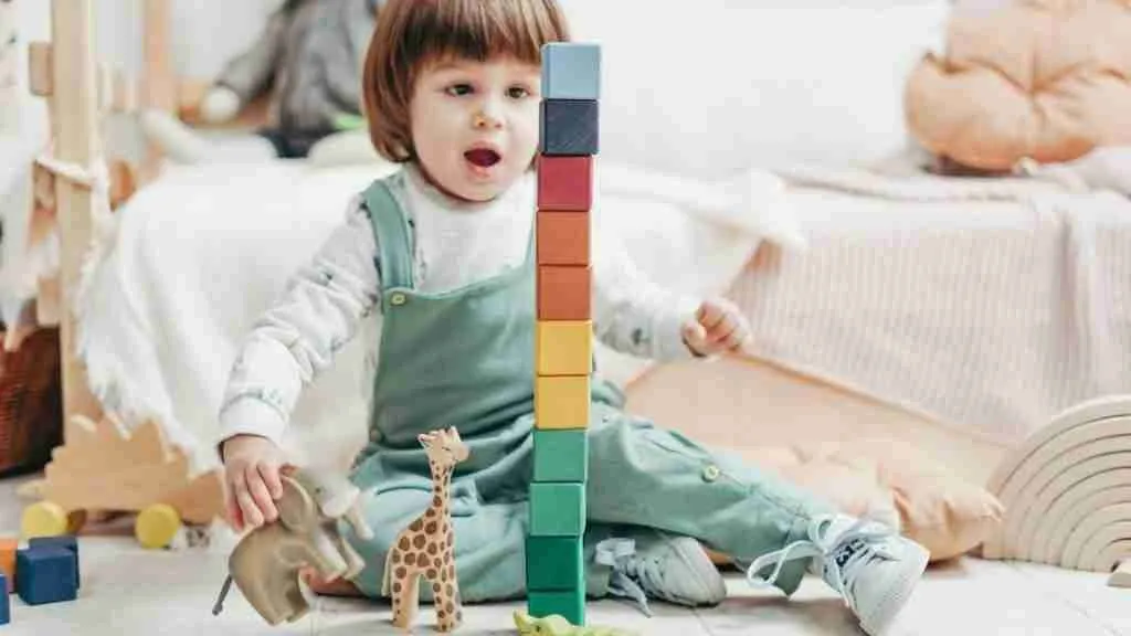 what is montessori play - child building with blocks